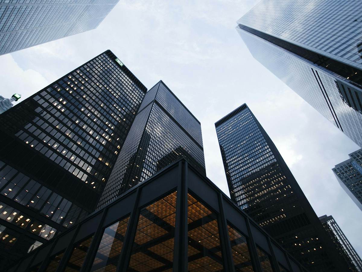 Glass office towers seen from street level.